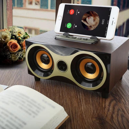 Compact Wooden Bluetooth Speaker For Home And Kitchen Use on table with phone docked playing hands-free calls and music
