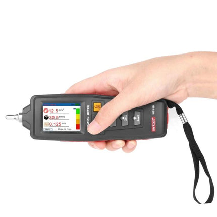 WINTACT Handheld Digital Vibration Analyzer for Maintenance Tools held in hand showing flipped color display and wrist strap