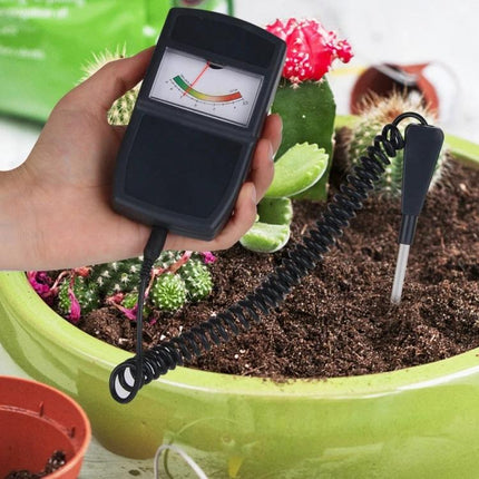 Digital Soil Moisture and pH Meter for Gardening Plant Care handheld meter inserted into pot to check soil moisture and pH