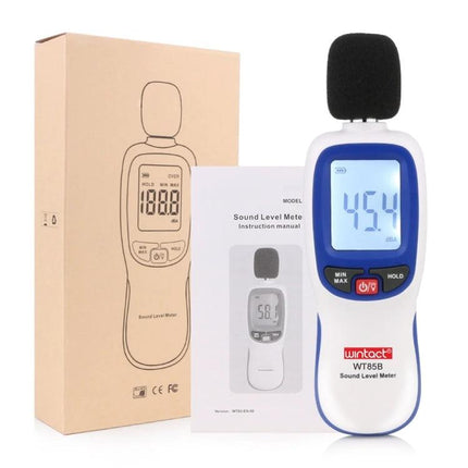 Digital Sound Level Meter for Environmental Noise Monitoring - handheld meter with foam windscreen showing 45.4 dB, packaging and manual