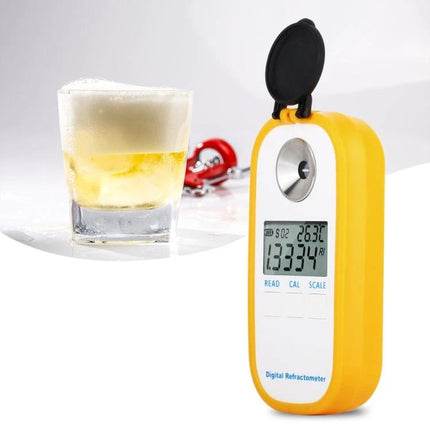 User-Friendly Digital Refractometer for Brewing Beer and Wine at Home showing yellow handheld device with digital display next to a glass of beer