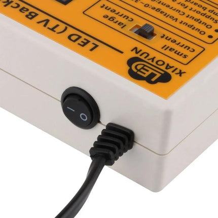Portable Handheld LED Tester for TV Backlight and Strip Testing showing power switch and cable connection on device