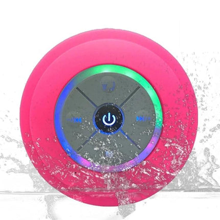 Compact Waterproof Shower And Beach Speaker With Suction Cup showing pink speaker with LED lights and water splash