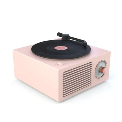 X10 Compact Retro Bluetooth Speaker With Rose Gold Dial on desk showing vinyl-style rotating disc and rose gold dial (100 chars)
