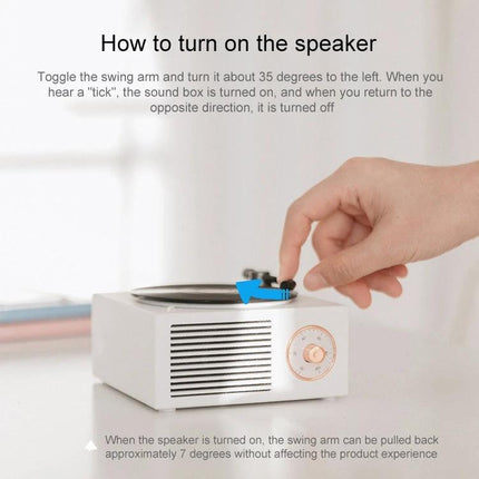 X10 Compact Retro Bluetooth Speaker With Rose Gold Dial on desk showing hand toggling swing arm to turn speaker on