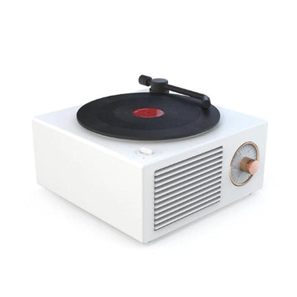 X10 Compact Retro Bluetooth Speaker With Rose Gold Dial on desk with vinyl-style rotating disc and rose gold dial