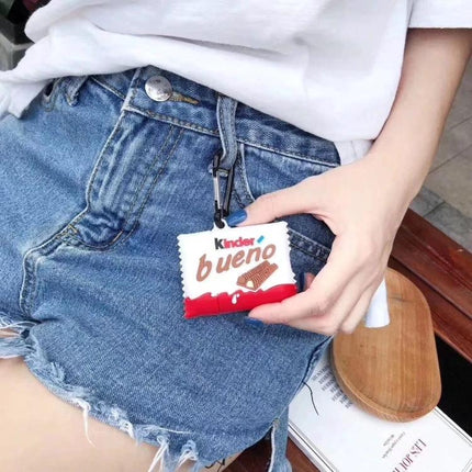 Protective Case for AirPods with Kinder Chocolate Style for Daily Carry showing white red Kinder Bueno inspired keychain case clipped to denim shorts