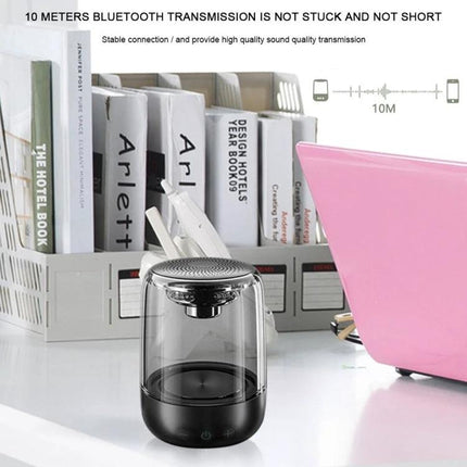 Portable Bluetooth Speaker With Ambient LED Light For Home on desk near books and laptop, transparent acrylic design