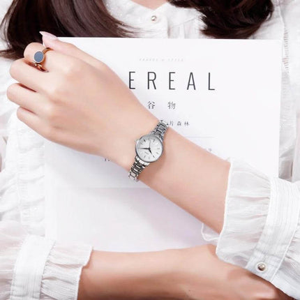 Skmei Steel Belt Quartz Watch for Women in Business Style on wrist with silver steel bracelet and white dial, professional office look