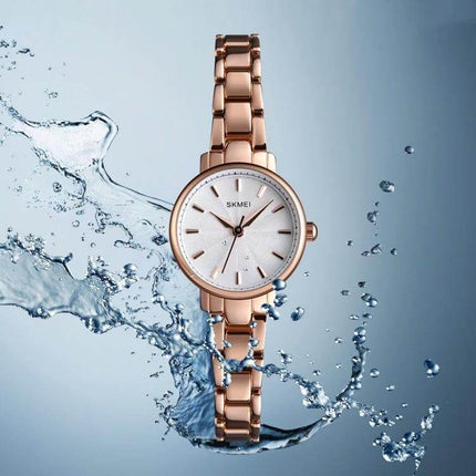Skmei Steel Belt Quartz Watch for Women in Business Style – rose gold stainless steel bracelet watch with minimalist white dial and water splash backdrop