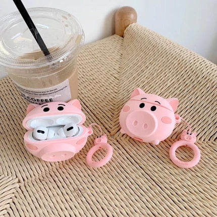 Cute Pig-Shaped Case for Everyday AirPods Protection showing pink pig silicone case with AirPods, dustproof anti-fouling exterior and ring accessory