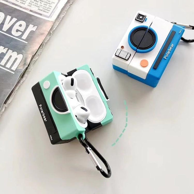Camera-Style Case for Everyday AirPods Protection showing two camera-shaped protective AirPods cases, one mint green open with earbuds and one blue closed