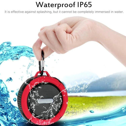Compact Bluetooth Car Speaker With Clip For Commuting shown clipped to hand with water splashes and IPX3/IP65 splash resistance
