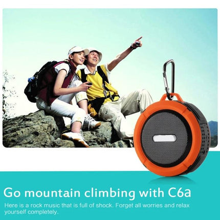 Compact Bluetooth Car Speaker With Clip For Commuting shown clipped to backpack, lightweight orange portable speaker for travel