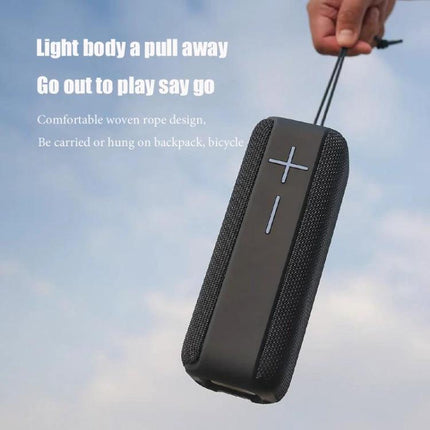 Portable Bluetooth Speaker With Carabiner For Outdoor Use shown clipped to a hand-held rope against sky, rugged fabric design