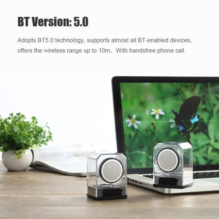 Transparent Portable Bluetooth Speaker With Waterproof Sleeve shown paired near laptop, clear casing and removable silicone sleeve
