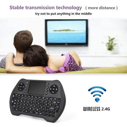 MT10 Fly Air Mouse 2.4GHz Wireless Mini Keyboard with Touchpad shown with couple on couch controlling smart TV via 2.4G wireless connection