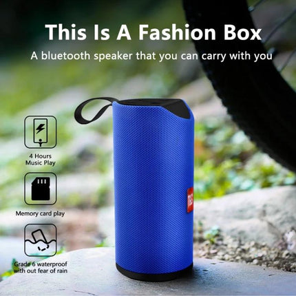 Portable Bluetooth Travel Speaker With FM Radio For Outdoor shown in blue portable cylinder with strap on outdoor rock