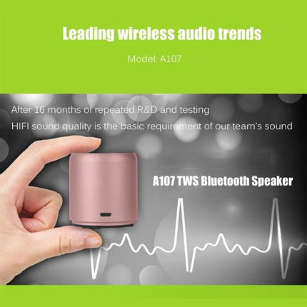 EWA Compact Portable Speaker For Home And Travel Use showing small cylindrical A107 Bluetooth speaker held between fingers