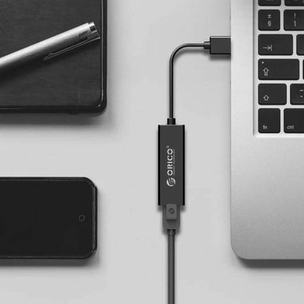 ORICO USB 2.0 to Ethernet Adapter for Wired Network Access plugged into a laptop providing stable wired connection for gaming streaming and remote work