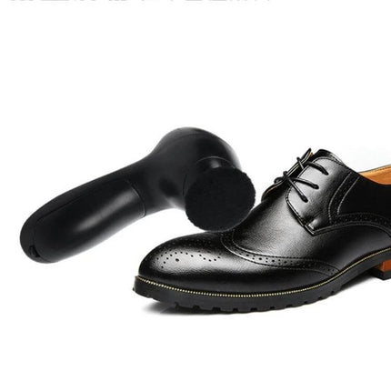 Shoe Dryer Portable for Leather Care and Maintenance – compact battery-powered plastic dryer next to black leather dress shoe