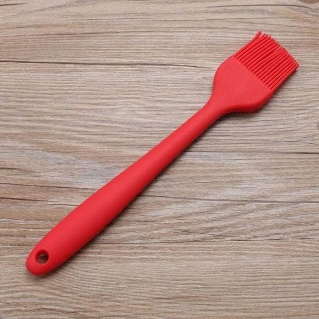Silicone BBQ Oil Brush For Easy Basting Of Grilled Foods - red silicone basting brush on wooden surface