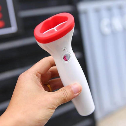 Silicone Lip Plumper Device, Electric Vacuum Tool For Daily Lip Care - white handheld silicone lip plumper with red rim held in hand