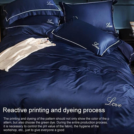Silk Four Piece Sheet Set Ice Silk Bedding 1.5 to 2.0m navy ice silk sheets on bed with pillows and embroidered ‘Love’