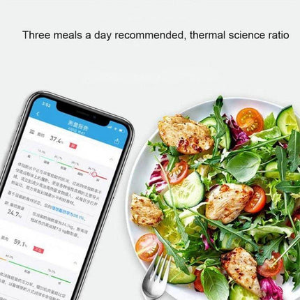 Smart Body Fat Scale Battery Powered For Everyday Home Use displaying app trend curves next to a healthy salad to illustrate daily tracking