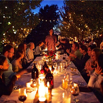 Smart Light Bulb Adapter With WiFi App Control For Home Lighting shown powering warm outdoor string lights at a dinner table scene
