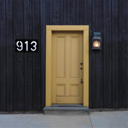Solar Door Plate Light For House Numbers Outdoor Night Use showing illuminated black house number plaque 913 beside yellow front door