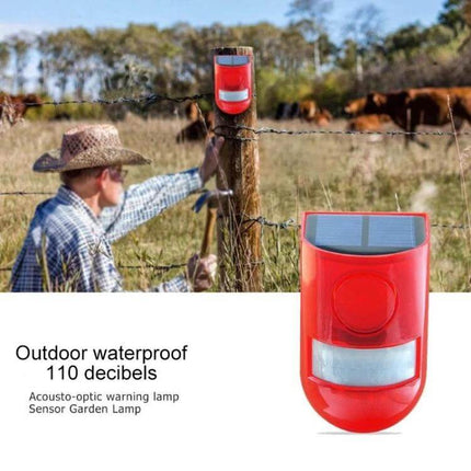 Solar Powered Sound Light Alarm Outdoor Waterproof System mounted on fence post showing red solar alarm with flashing LEDs and farmer installing it