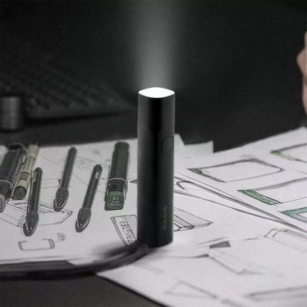 SOLOVE LED Flashlight USB Type C Portable Light for Everyday Use - compact USB-C rechargeable LED torch shown projecting light on sketches