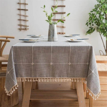 Square Lattice Embroidered Tablecloth, Tassel Border on wooden dining table with vase centerpiece and neutral decor