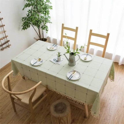 Square Lattice Embroidered Tablecloth, Tassel Border on dining table with green linen-style fabric and tassel trim