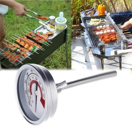 Stainless Steel Oven Thermometer for BBQ Grilling with Dual Display positioned next to outdoor grills and skewers for accurate temperature readout