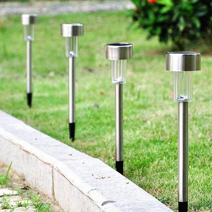 Stainless Steel Solar Garden Light For Outdoor Pathways lining a lawn edge to illuminate walkways and patios at night