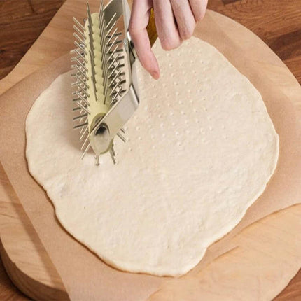 Stainless Steel Rolling Pin With Wooden Handle For Pizza And Snacks used to roll and dock pizza dough on parchment