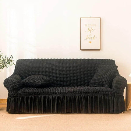Stretch Sofa Cover With Skirt for Double M 145-185cm Sofas in black seersucker fabric with lotus-leaf skirt and straps protecting sofa