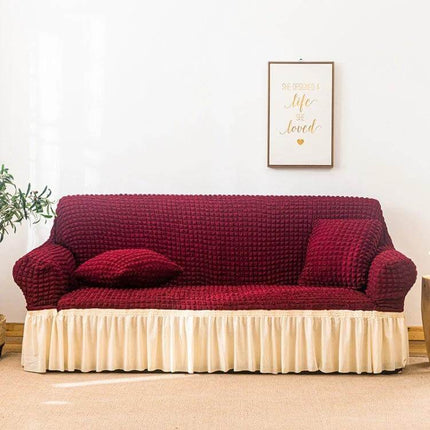 Stretch Sofa Cover With Skirt for Double M 145-185cm Sofas in burgundy seersucker fabric with lotus-leaf cream skirt protecting sofa from spills and pet hair