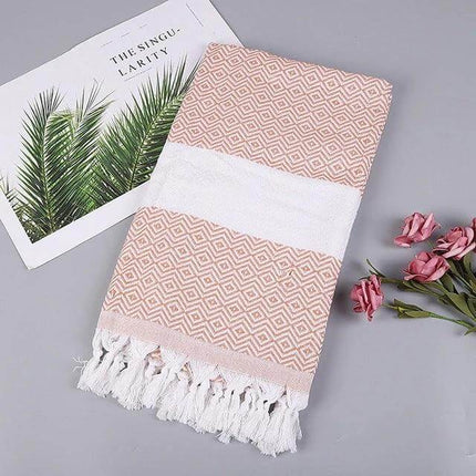 Striped Cotton Bath Towel With Tassels For Everyday Use folded pink geometric cotton-linen towel with white band and tassels, 100x180 cm, versatile