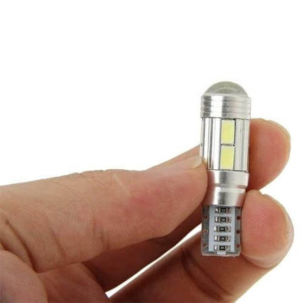 Hand holding a T10 White LED Bulb for Vehicle Turn Signals and Tail Lights showing LED elements and metal base