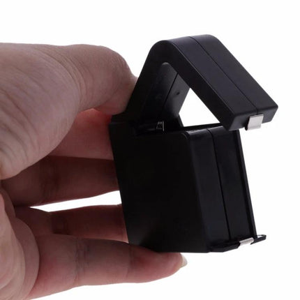 Portable Analog Battery Tester for 9V and 1.5V Cells compact handheld unit in hand for checking 9V and 1.5V batteries, travel and electronics use