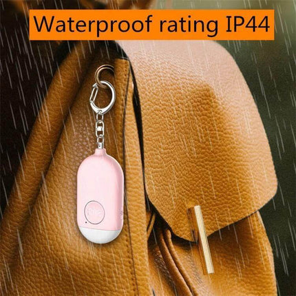 Rechargeable Personal Safety Alarm with Flashlight for Daily Protection hanging on a bag in rain showing IP44 waterproof rating