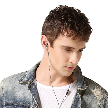 Wired Earphones With Ear Hook Fit And Inline Mic For Commute shown worn by young man in denim jacket, 3.5mm wired in‑ear