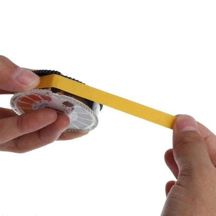 pH Test Paper Roll for Checking Acidity in Daily Liquids — hands pulling yellow pH test strip from roll with color comparison wheel for home water and aquarium checks