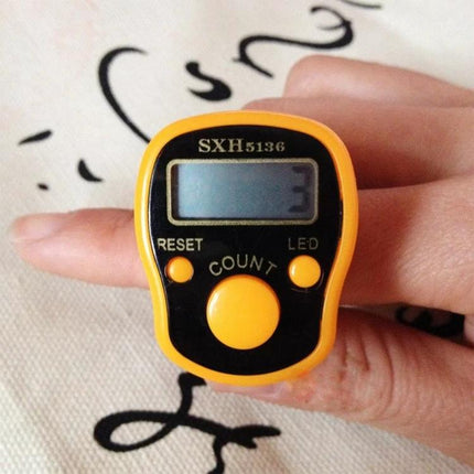 RV77 Portable Digital Finger Counter for Everyday Use showing yellow finger-worn tally device with luminous display reading 3