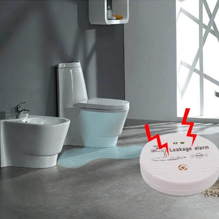 Household Water Leak and Overflow Detection Alarm placed near bathroom toilet detecting leaking water