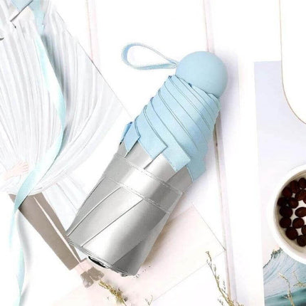Compact Mini Pocket Umbrella for Everyday Sun and Rain Protection — light blue compact umbrella, 260g, fits in bag or pocket for commuters
