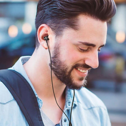 Langsdom Wired In Ear Earphones For Commuting And Calls - man commuting with secure-fit wired in-ear earphones and 3.5mm jack